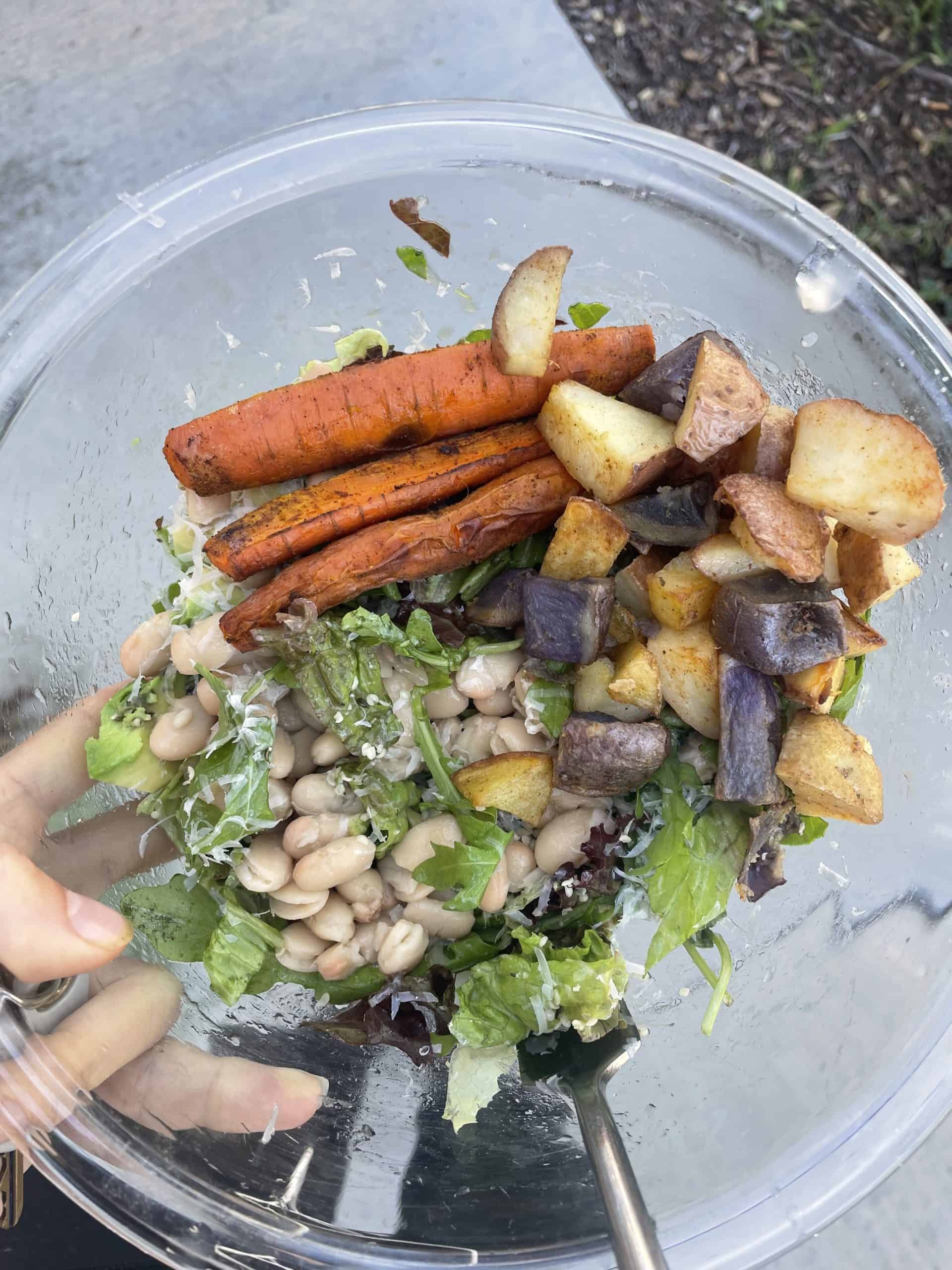 carrots, potatoes, white beans and salad in a clear bowl