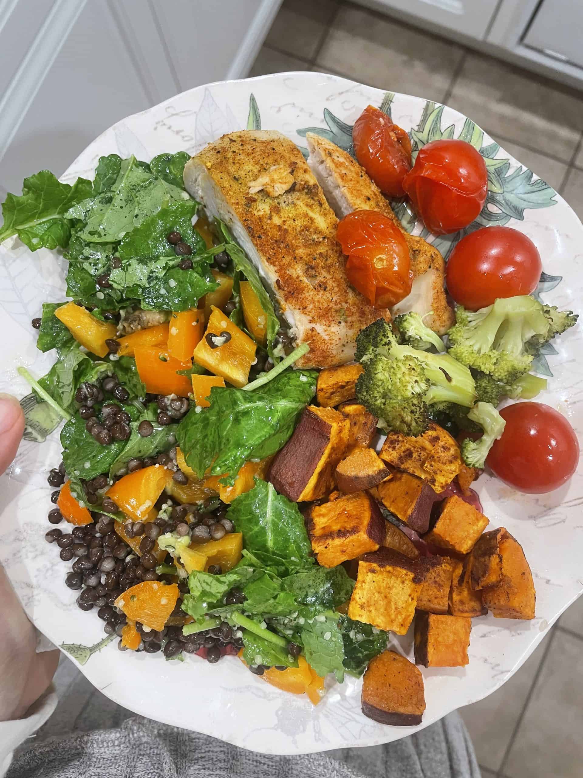 roasted chicken with tomatoes, sweet potatoes and a salad on the side