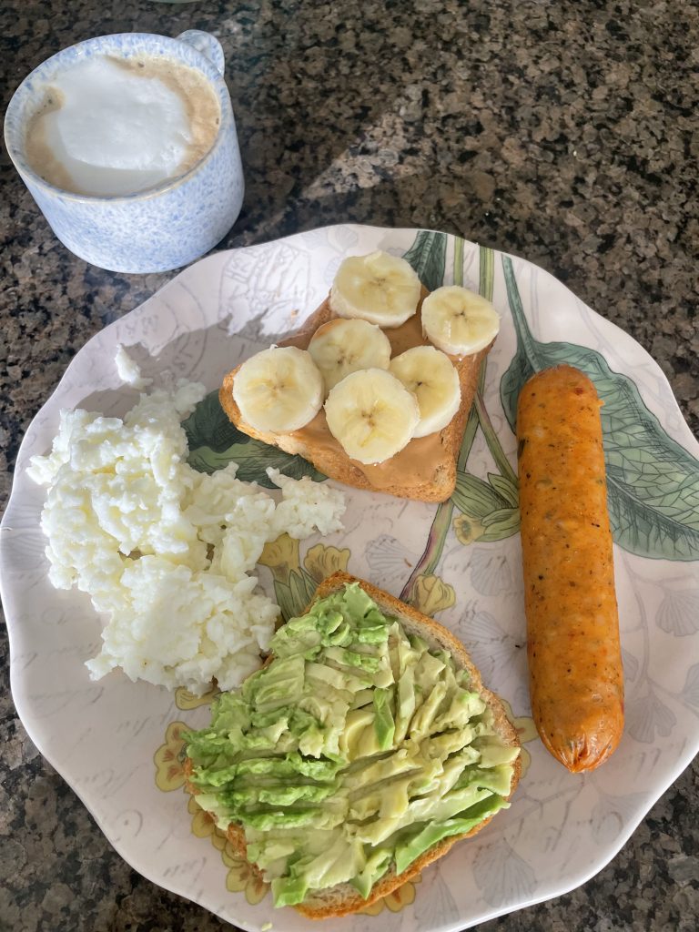 plat with avocado toast, eggs whites, toast with peanut butter and banana and a breakfast sausage